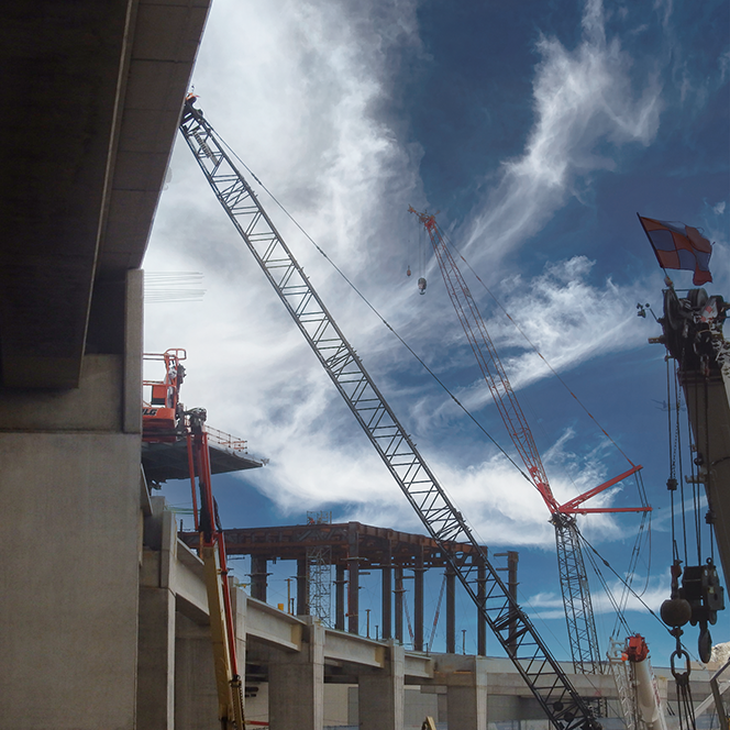  Cranes alongside an overpass bridge barrier at LaGuardia Airport